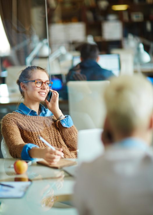Young manager talking on the cellphone in office