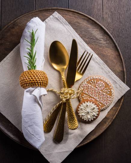 Christmas table place setting with vintage silverware and gingerbread. Christmas dining concept background.