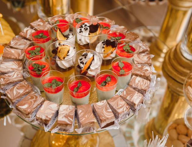 Delicious sweets on wedding candy buffet with desserts, cupcakes,tiramisu and cookies